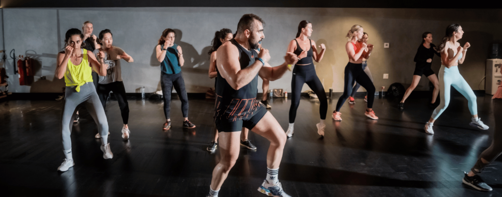 the trainer is teaching others a strength activity