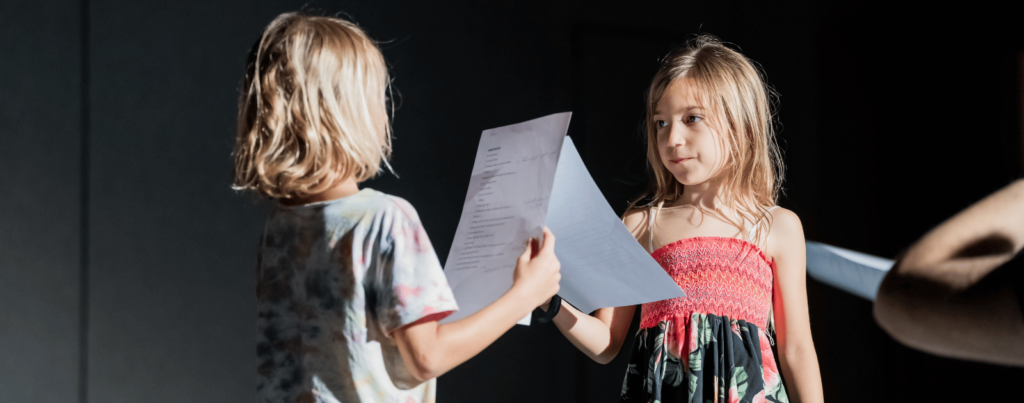 two girls are role playing a dialogue which they have trained for