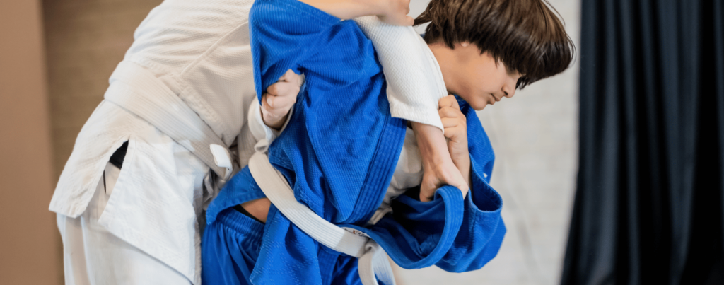 two kids are performing martial arts