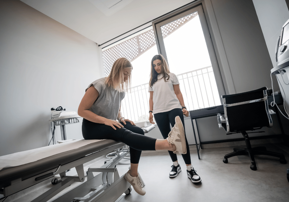 a woman is helping another woman with stretching