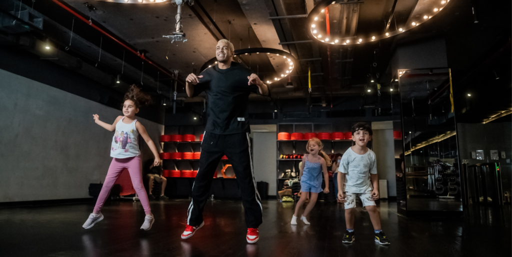 Dance trainer teaching kids dance
