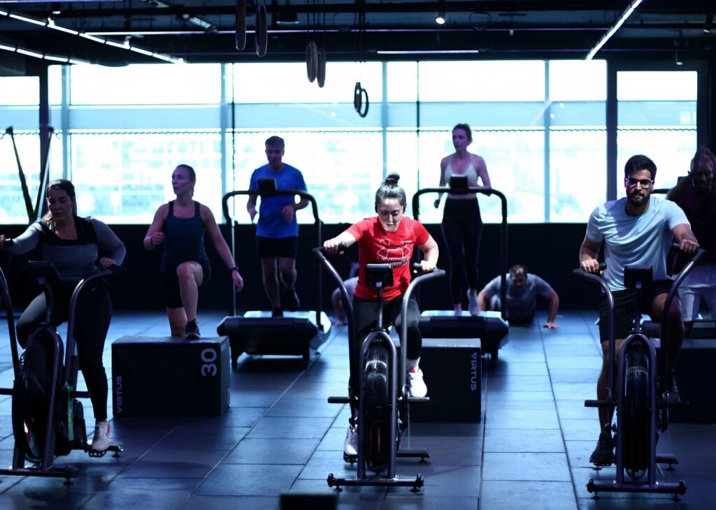 A group of people working out on cycling machines